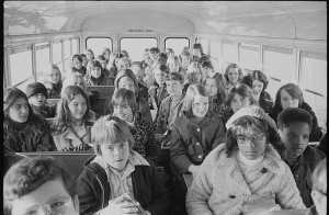African American and white school children on a school bus.