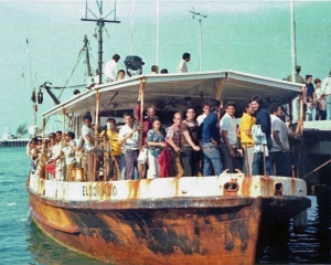 A rusty boat named the El Dorado arriving in Key West with dozens of Cuban migrants standing on the deck.
