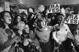 Women holding signs in support of or against the Equal Rights Amendment.