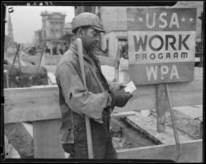 Man in overalls looking at paycheck in front of sign reading USA Work Program WPA.