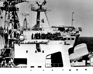 A large crowd of Warsaw Pact officers gathered on the upper decks of a Soviet Udaloy-class anti-submarine missile destroyer.