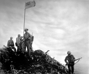 Members of a 40-man patrol planting the first American flag at Iwo Jima.