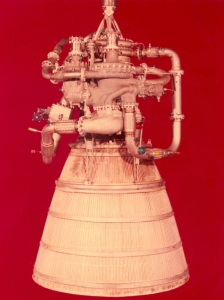 The XLR115 liquid-hydrogen-fueled rocket engine against a red background.